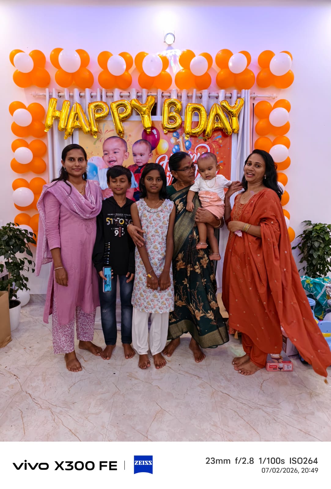 Family with grandmother and children at the Happy Bday backdrop
